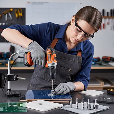Femme utilisant la scie cloche pour carrelage pour percer céramique