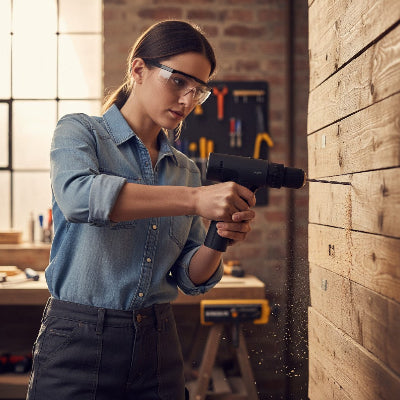 jeune femme utilisant la perceuse et visseuse sans fil 